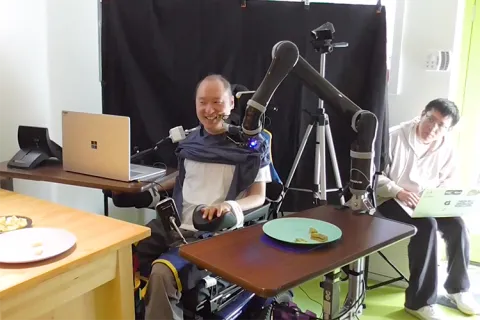 Man testing out assistive feeding robot